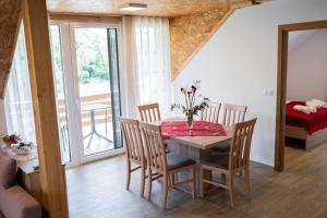 a dining room with a table and chairs and a balcony at Ribnik Stari trg in Lesično