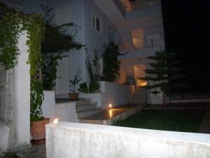 a house with lights on the side of it at night at Agia Efimia seaside 2br apartment in Agia Effimia