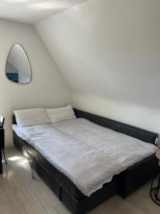 a bed in a room with a white wall at 1 Bedroom Flat in Bedford in Bedford