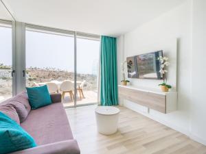 a living room with a couch and a large window at Beyond Amadores 11 in Mogán