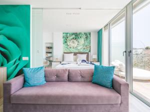 a living room with a couch in front of a bed at Beyond Amadores 11 in Mogán +55 photos