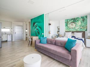 a living room with a couch and a bed at Beyond Amadores 11 in Mogán