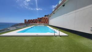 a swimming pool on the side of a building at Beyond Amadores 11 in Mogán