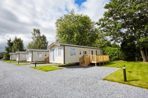 a couple of mobile homes parked in a driveway at Braidhaugh Holiday Lodge and Glamping Park in Crieff