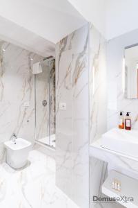 a white bathroom with a shower and a sink at Olivia's Home By DomusExtra in Naples +34 photos