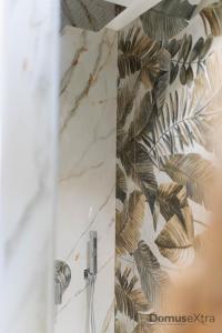a bathroom with a marble wall with a plant mural at Olivia's Home By DomusExtra in Naples