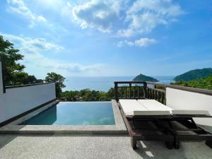 a view from the balcony of a villa with a pool at Dusit Buncha Koh Tao by Riya Group in Ko Tao