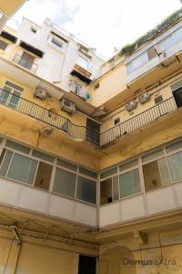 an apartment building with windows and a balcony at Olivia's Home By DomusExtra in Naples
