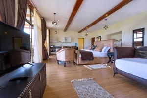 un salon avec un lit et un canapé dans l'établissement Sleeping Warrior Camp Elementaita, à Nakuru