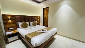 Postel nebo postele na pokoji v ubytování Hotel Arma Residency