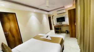 Postel nebo postele na pokoji v ubytování Hotel Arma Residency