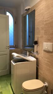 a bathroom with a toilet and a sink at Appartamenti Miravalle in Maratea +23 photos