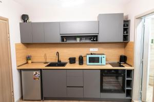 a kitchen with a sink and a microwave at Apartmenthaus Oborishte - 27 in Panagyurishte