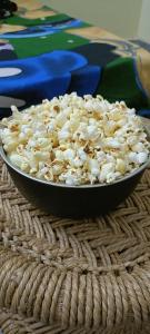 a bowl of popcorn on top of a table at Nikunj Dorme in Rājgīr +30 photos