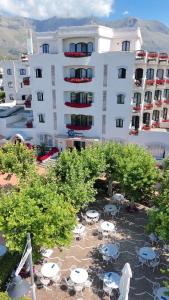 a large white building with tables and chairs in front of it at BAJAMAR BEACH HOTEL in Formia +59 photos