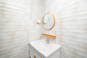 a white bathroom with a sink and a mirror at Changsha Fuxiangyuan International Hostel in Changsha