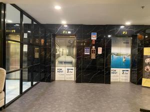 a room with two doors with signs on the wall at Trieak Skyview Apartment in Sunggal