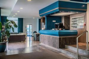a lobby of a hotel with a blue wall at Hotel Orizzonte in Lido di Jesolo
