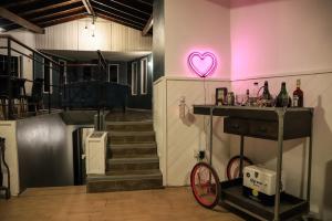 a room with a heart neon sign on the wall at Alto Belgrano Casas Bariloche in San Carlos de Bariloche +35 photos