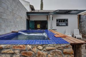 a plunge pool in a house with blue tiles at Kookfontein Farm Cottages in Lambertʼs Bay
