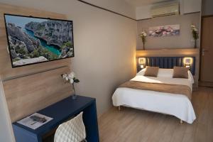 Кровать или кровати в номере Hotel Le Golfe