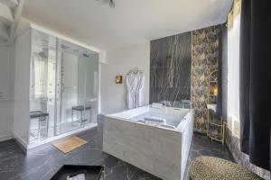 a bathroom with a sink and a glass shower at Suite 90m2 avec Jacuzzi jardin Proche Paris CDG in Livry-Gargan +15 photos