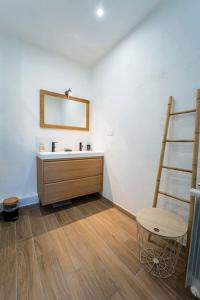 a bathroom with a sink and a wooden ladder at Charmant T2 proche Place aux Herbes in Uzès +39 photos