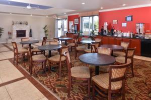 a restaurant with tables and chairs and a fireplace at Americas Best Value Inn Lubbock East in Lubbock