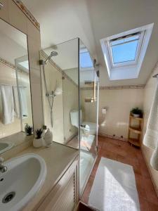 a bathroom with a sink and a shower at Caparica Golf & Beach Accomodation in Almada