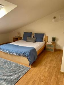 a bedroom with a large bed with blue pillows at Caparica Golf & Beach Accomodation in Almada +31 photos