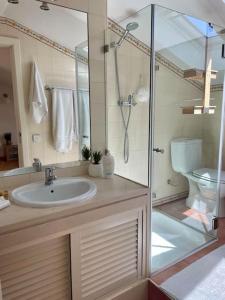 a bathroom with a sink and a shower and a toilet at Caparica Golf & Beach Accomodation in Almada +33 photos