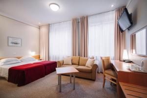 מיטה או מיטות בחדר ב-Rixwell Viru Square Hotel