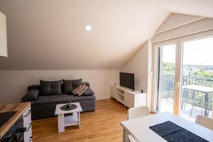 a living room with a couch and a tv at Villa Lucija in Milna