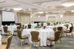 a conference room with white tables and chairs at Hilton Greenville in Greenville