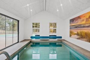 a swimming pool in a room with a large window at Exclusive Pool And Activity House For 30 People -1002 in Ringkøbing