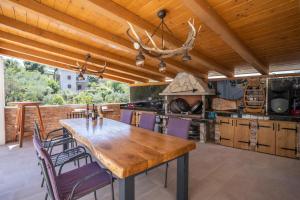 a large kitchen with a wooden table and chairs at Villa Lucija in Milna