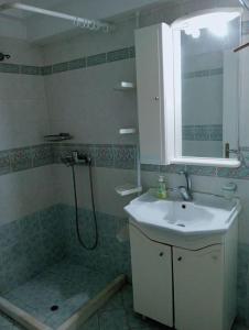 a bathroom with a sink and a shower at 35m2 apt close to beach in Lygia +7 photos