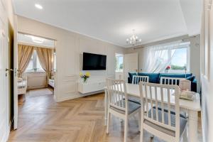 a kitchen and living room with a table and chairs at Endla Residence in Tallinn