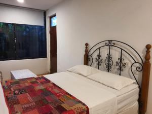 a bedroom with a bed with a quilt on it at Holiday Rental Mattegoda Sri Lanka in Mattegoda