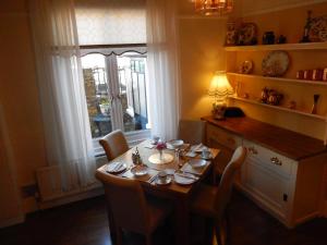 a dining room with a table and chairs and a window at The Rutlands B&B in Windsor