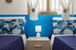 A bed or beds in a room at Villa Dema, sea front & beach 20 mt