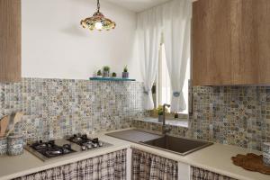 A kitchen or kitchenette at Villa Dema, sea front & beach 20 mt