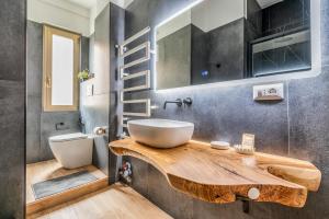 a bathroom with a sink on a wooden counter at 4 Pax Wi-Fi Milano Lorenteggio in Milan +12 photos
