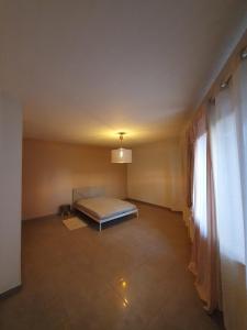 a bedroom with a bed in a room with a window at MAT Flat in Liège