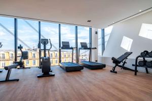 a gym with treadmills and exercise equipment in a building at Doubletree By Hilton Nice Centre Iconic in Nice
