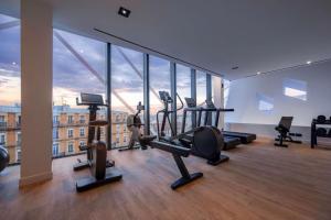 a gym with treadmills and exercise equipment in a building at Doubletree By Hilton Nice Centre Iconic in Nice
