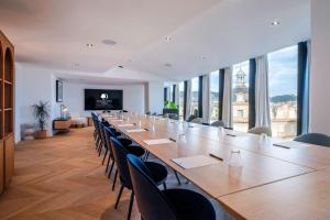 a large conference room with a long table and chairs at Doubletree By Hilton Nice Centre Iconic in Nice