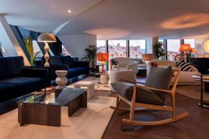 a living room with couches and chairs at Doubletree By Hilton Nice Centre Iconic in Nice