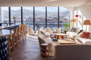 a restaurant with chairs and tables and windows at Doubletree By Hilton Nice Centre Iconic in Nice
