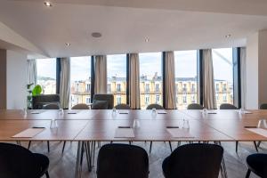 a meeting room with a large table and chairs at Doubletree By Hilton Nice Centre Iconic in Nice